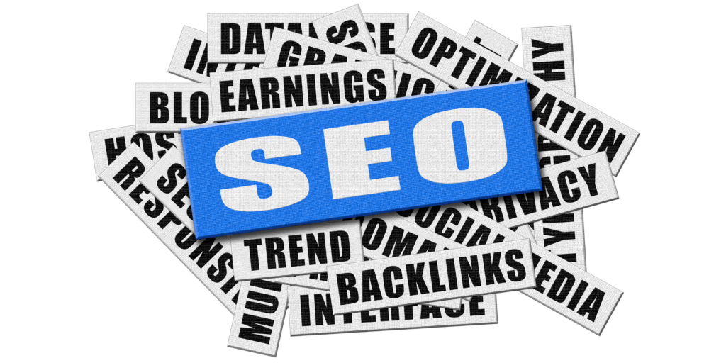 A blue SEO label placed on top of a pile of overlapping keyword tags including backlinks, trends, earnings, optimization, social media, privacy, and interface, representing search engine optimization concepts.